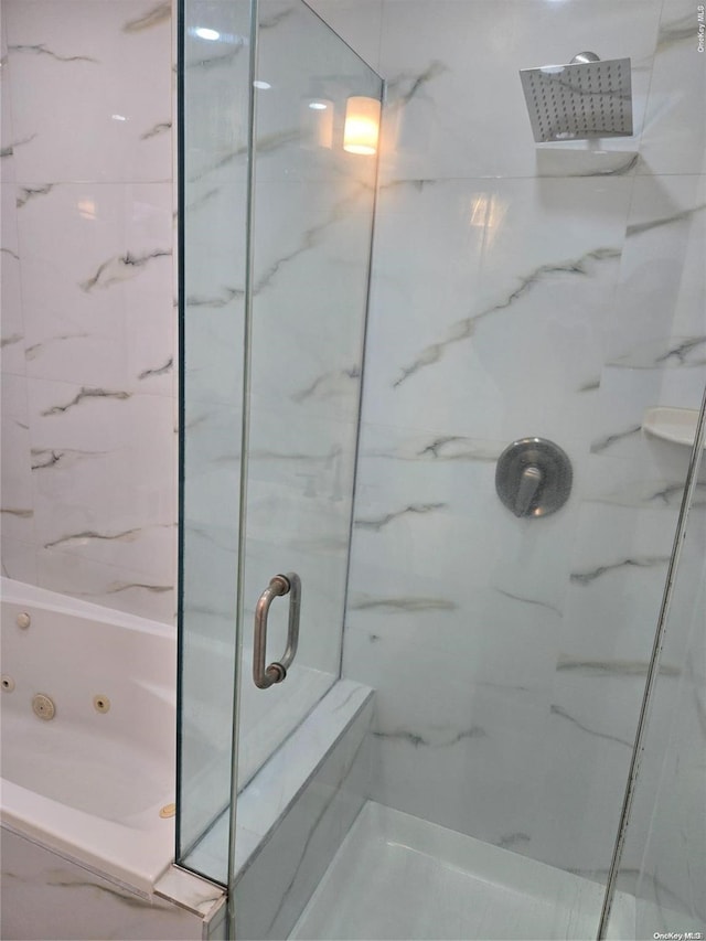 bathroom featuring shower with separate bathtub