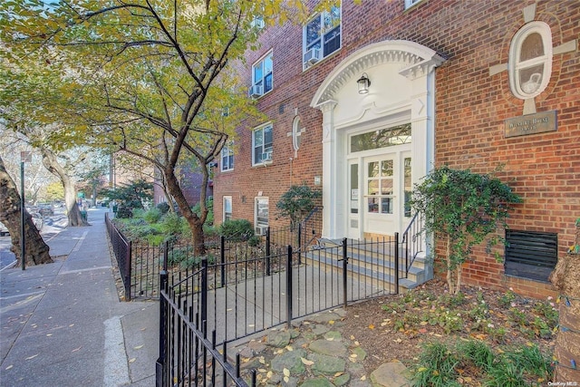 entrance to property featuring brick siding