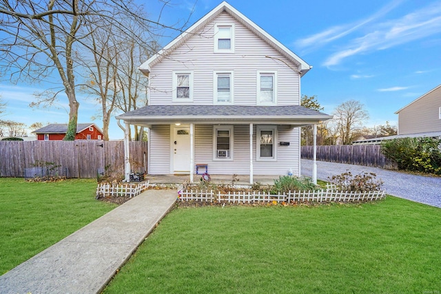 view of front of property featuring covered porch and a front yard