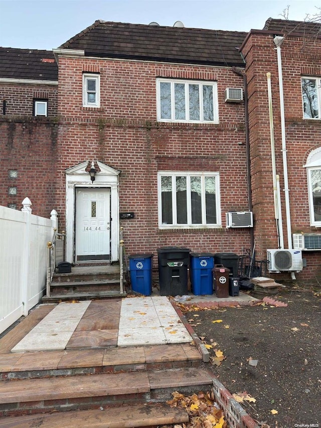 view of property with an AC wall unit and ac unit