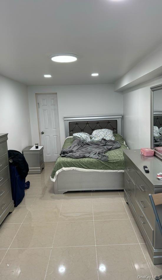 bedroom featuring light tile patterned flooring