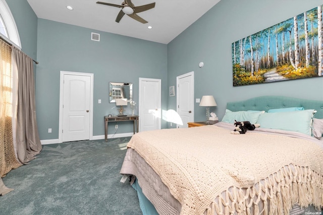 bedroom featuring ceiling fan, carpet floors, and a towering ceiling