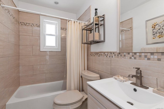 full bathroom featuring shower / bath combo, toilet, tile walls, and vanity