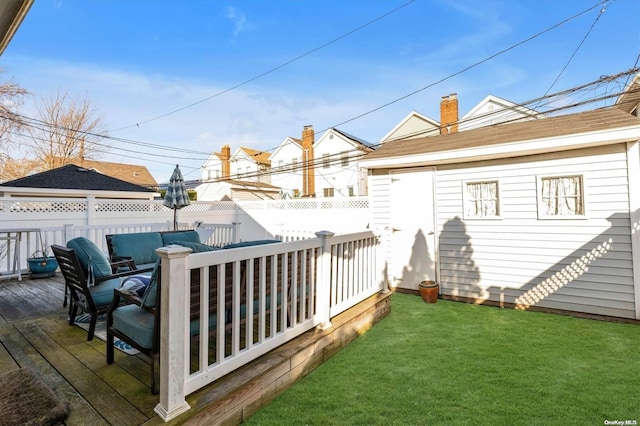 wooden terrace featuring a yard