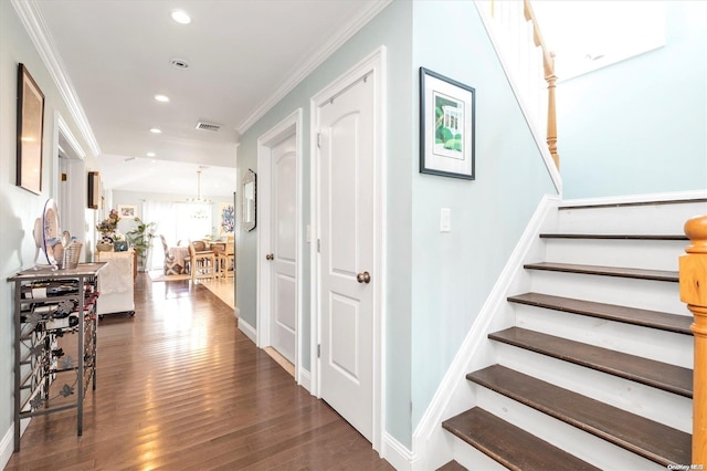 corridor with dark wood-type flooring and ornamental molding