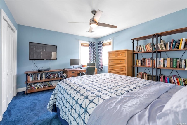 carpeted bedroom with ceiling fan and a closet