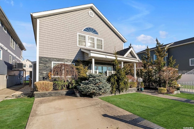 front of property with a front yard and central air condition unit