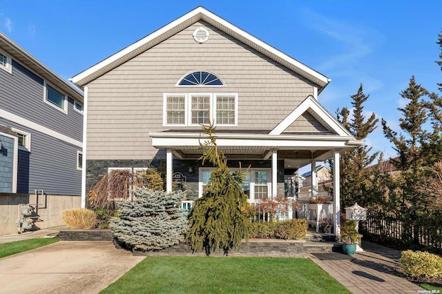 view of front facade with a front yard and a porch