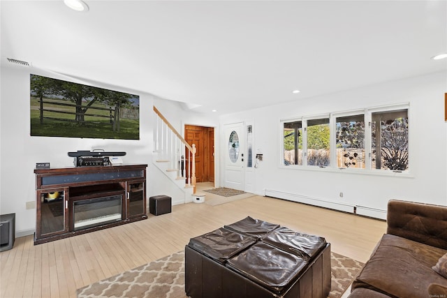 living room featuring hardwood / wood-style flooring and a baseboard heating unit