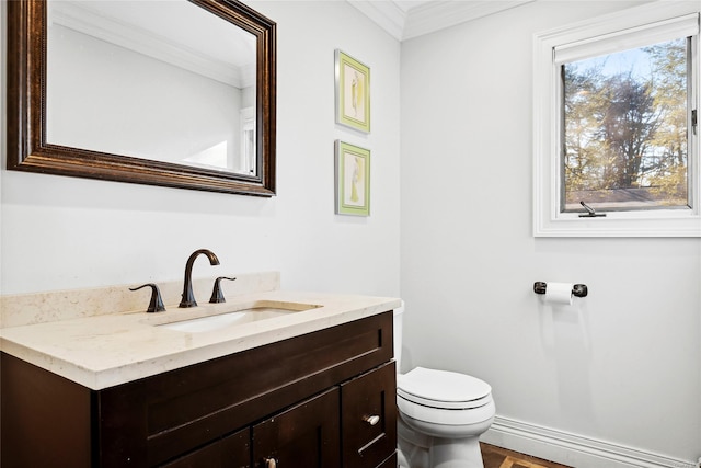 bathroom featuring vanity, toilet, and ornamental molding