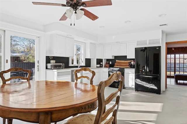 dining area with ceiling fan and sink