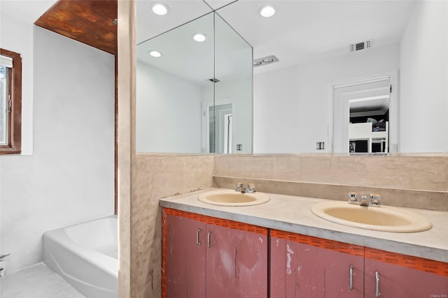 bathroom featuring a bathing tub and vanity