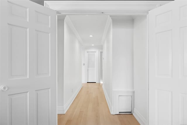 corridor featuring light hardwood / wood-style flooring and ornamental molding