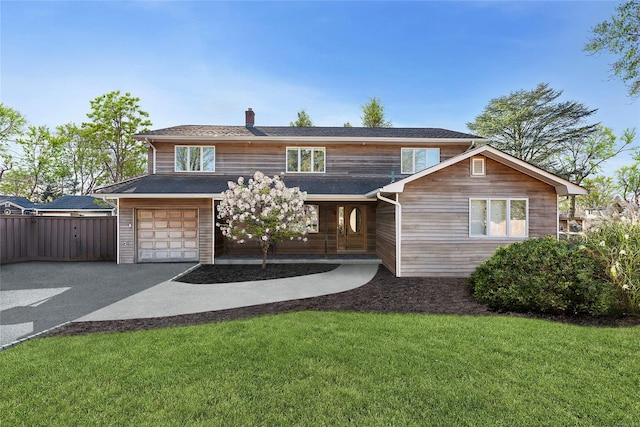 view of front facade featuring a front yard and a garage