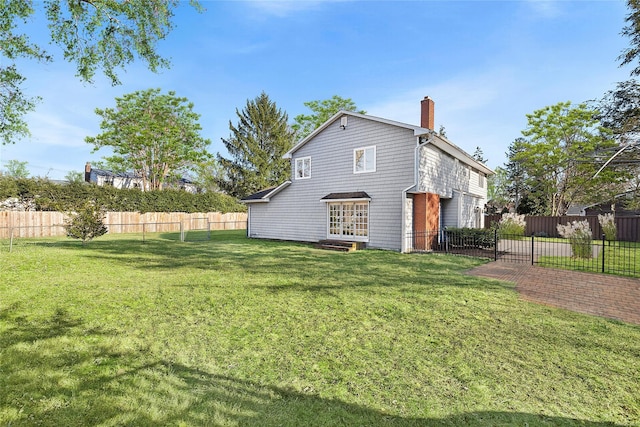 rear view of property with a lawn