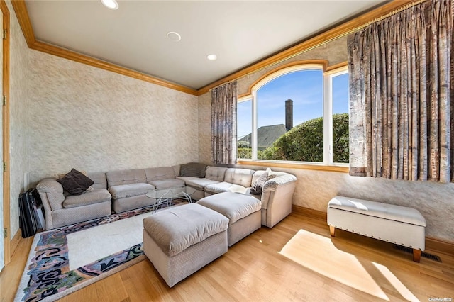 living room featuring crown molding, a mountain view, and light hardwood / wood-style floors