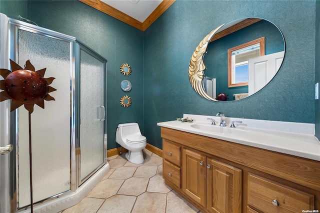 bathroom with tile patterned floors, toilet, vanity, a shower with shower door, and ornamental molding