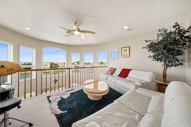 living room with carpet floors and ceiling fan