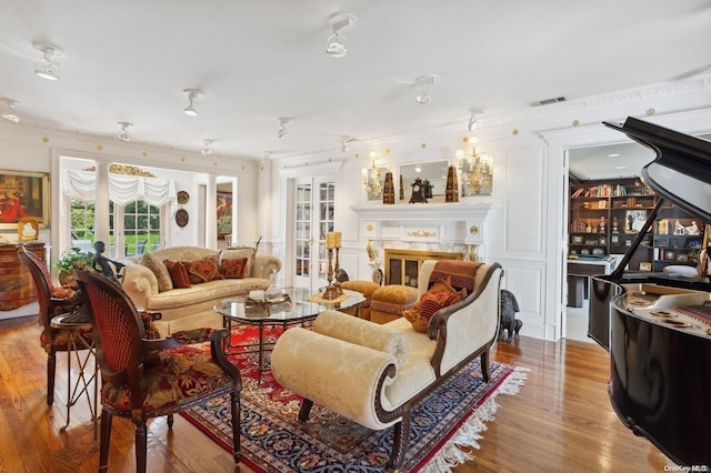 living room with a premium fireplace and light wood-type flooring