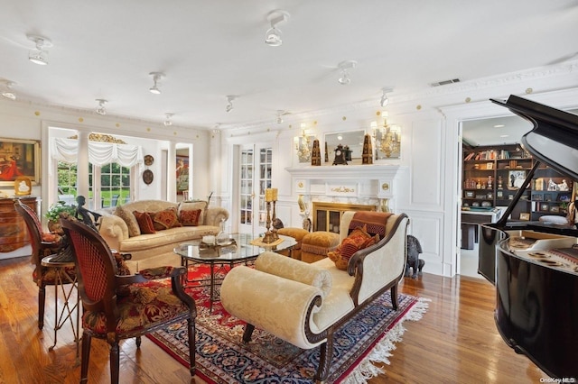 1345 Harbor Rd, Hewlett Harbor, NY 11557 - living area with wood finished floors, a premium fireplace, and crown molding