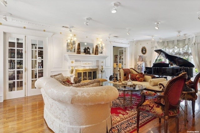 1345 Harbor Rd, Hewlett Harbor, NY 11557 - living room featuring a high end fireplace, light wood-style flooring, and ornamental molding