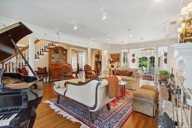 living room with decorative columns and hardwood / wood-style flooring