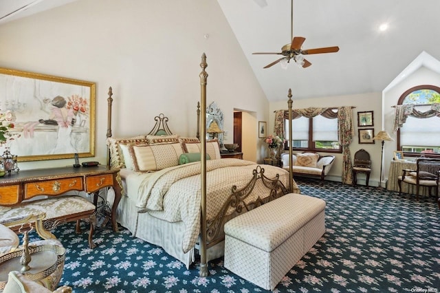 carpeted bedroom with ceiling fan and high vaulted ceiling