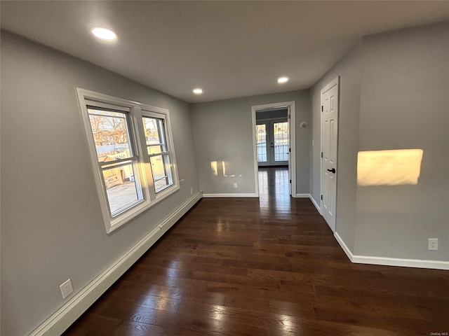 corridor with french doors, dark hardwood / wood-style flooring, and baseboard heating