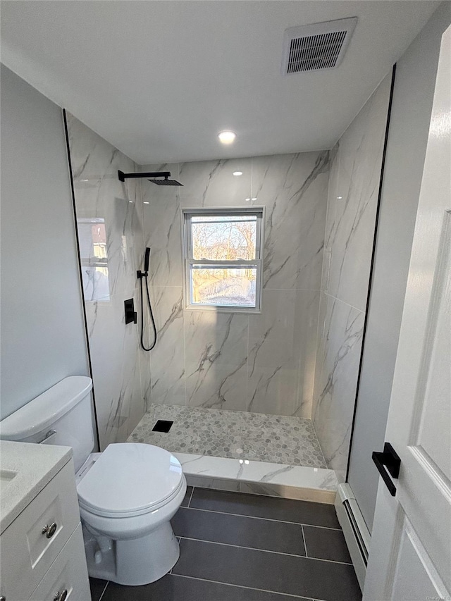 bathroom featuring toilet, a baseboard radiator, vanity, and tiled shower