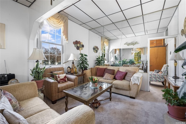 living room featuring light colored carpet and a high ceiling