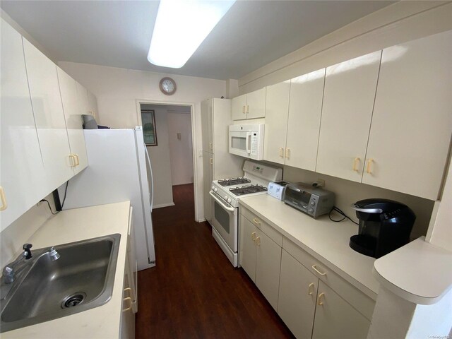 5 Schenck Ave Unit 3E, Great Neck, NY 11021 - kitchen featuring white appliances, a sink, dark wood-type flooring, light countertops, and white cabinets