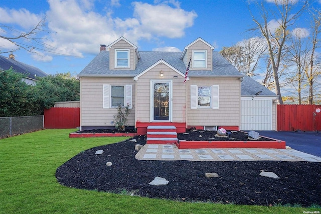 cape cod home featuring a front lawn