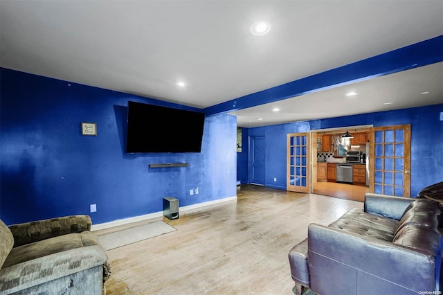 living room featuring french doors and light wood-type flooring