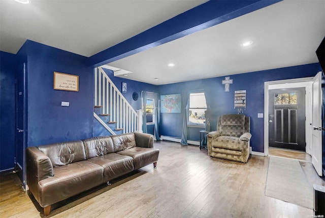 living room featuring plenty of natural light and light hardwood / wood-style flooring