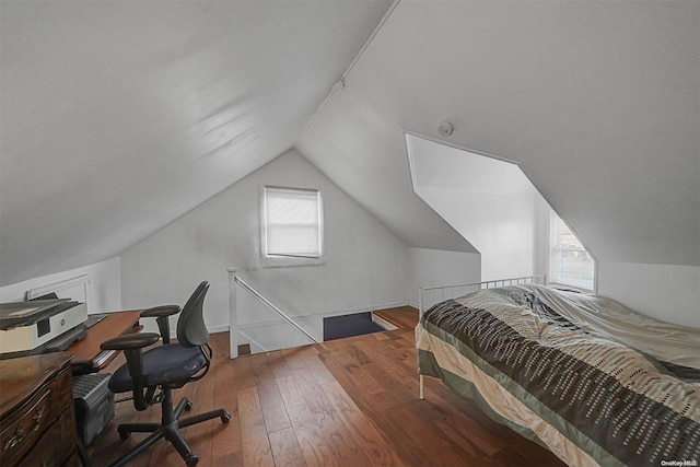 bedroom with hardwood / wood-style floors and vaulted ceiling