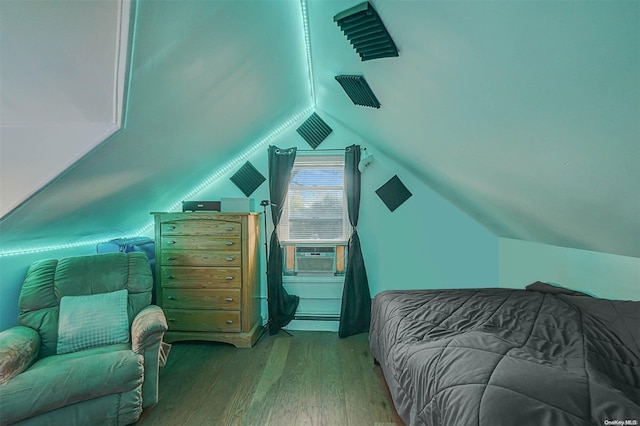 bedroom featuring lofted ceiling, cooling unit, wood-type flooring, and baseboard heating