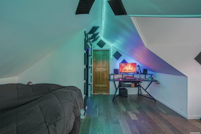 bedroom featuring hardwood / wood-style floors and lofted ceiling