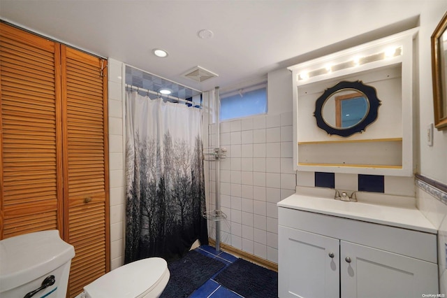 bathroom featuring curtained shower, tile patterned floors, toilet, vanity, and tile walls