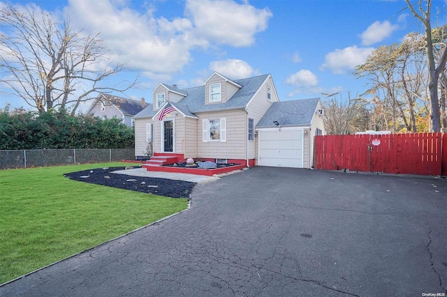 view of front of home with a garage and a front lawn