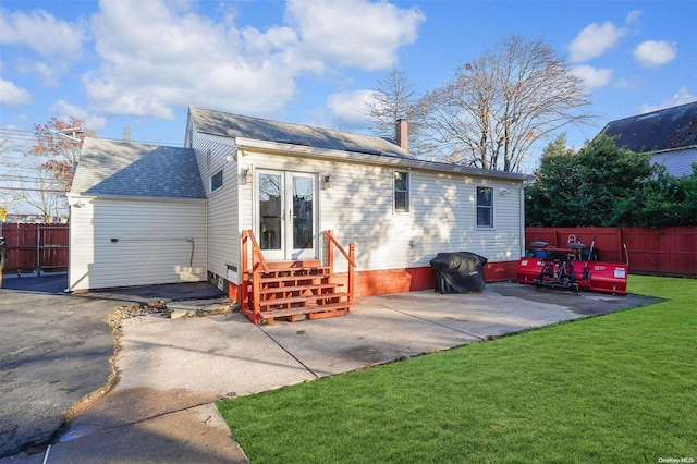 back of house with a lawn, a patio area, and french doors