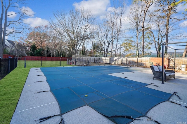 view of pool featuring a yard, a patio, and a diving board