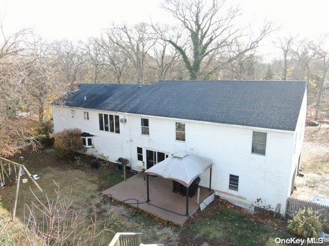 rear view of house featuring a patio and fence