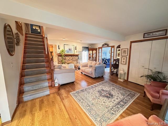 living area featuring light wood finished floors and stairs