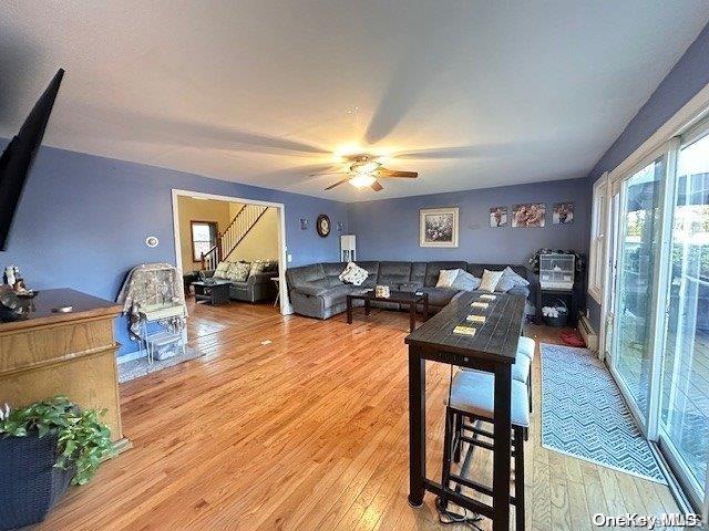 dining area with light wood-style flooring and a ceiling fan