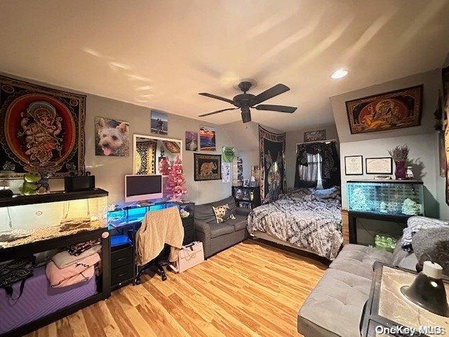 bedroom with hardwood / wood-style flooring and ceiling fan