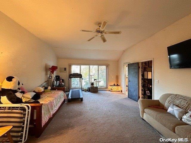 carpeted bedroom featuring vaulted ceiling and a ceiling fan