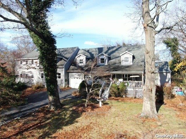 cape cod house featuring a porch