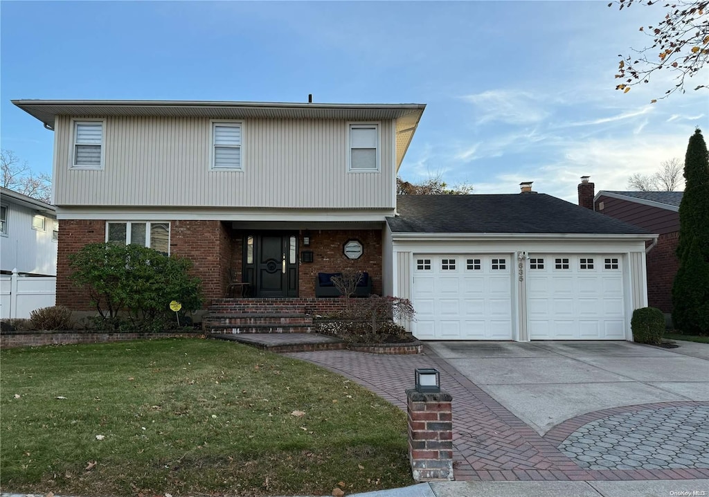 front of property featuring a garage and a front yard