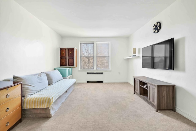 living room featuring radiator heating unit and light carpet