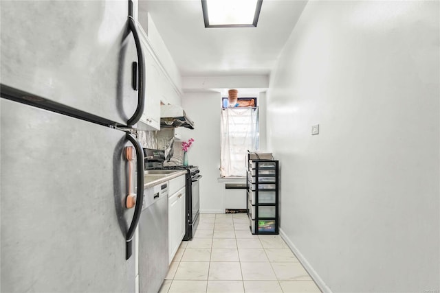 kitchen featuring white cabinets, light tile patterned floors, and stainless steel appliances